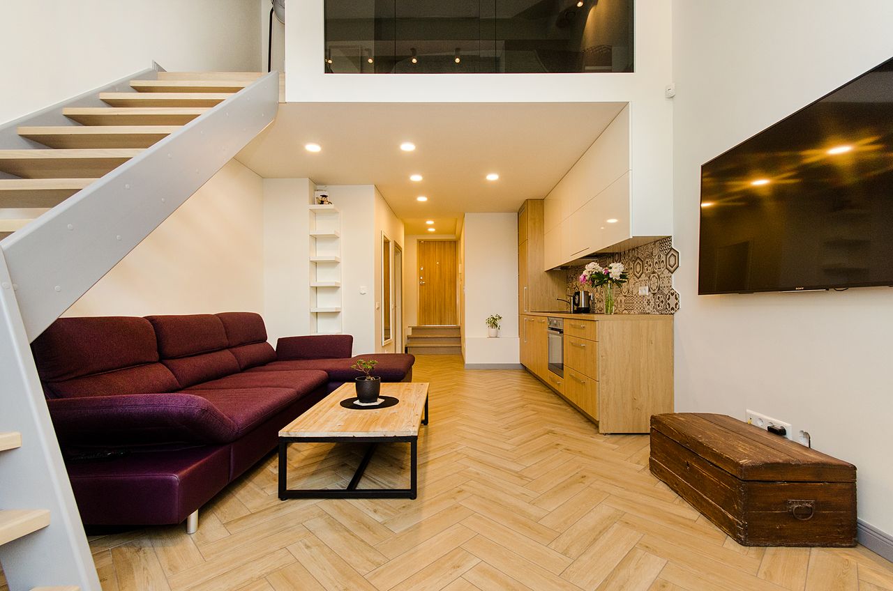 Spacious modern loft with elegant design including a kitchen and living area.