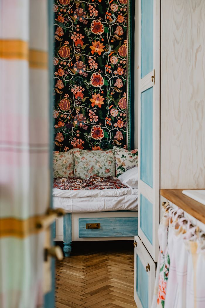 Inviting bedroom interior featuring vintage floral decor and cozy atmosphere.
