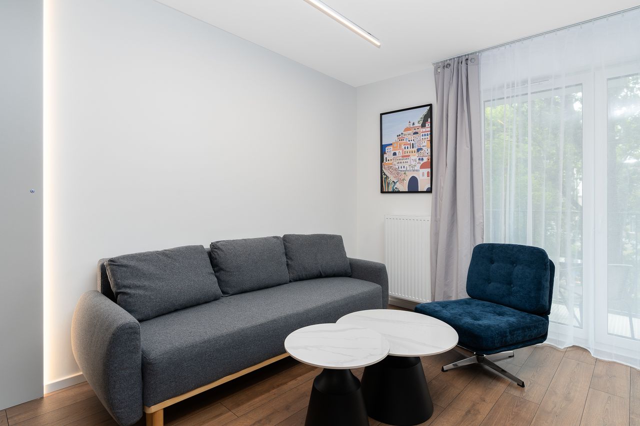 Contemporary living room featuring modern furniture and minimalist decor with ample natural light.